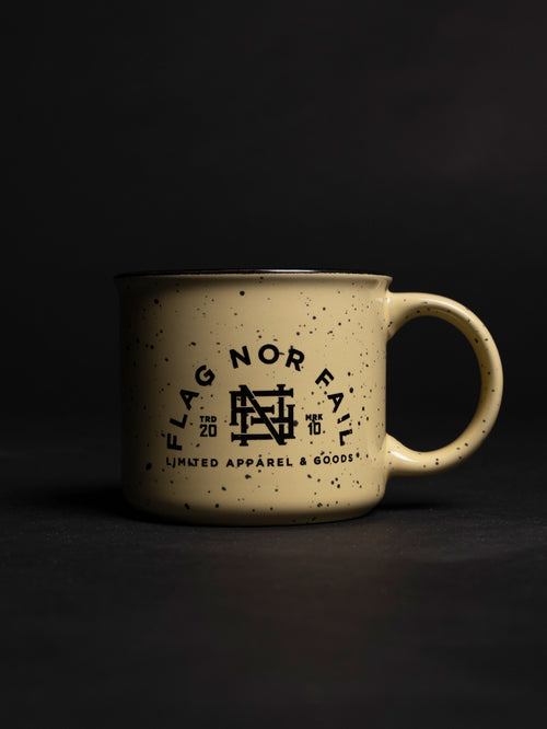 Ceramic mug. Almond color speckled black. Featuring a black Flag nor Fail logo.