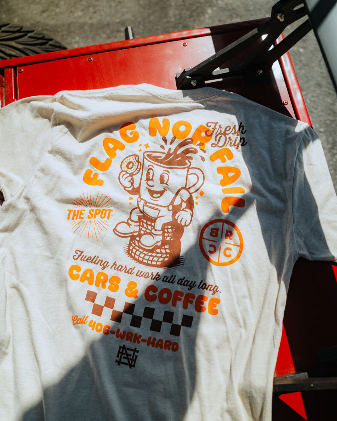 T-shirt with graphic design and text on a red vehicle