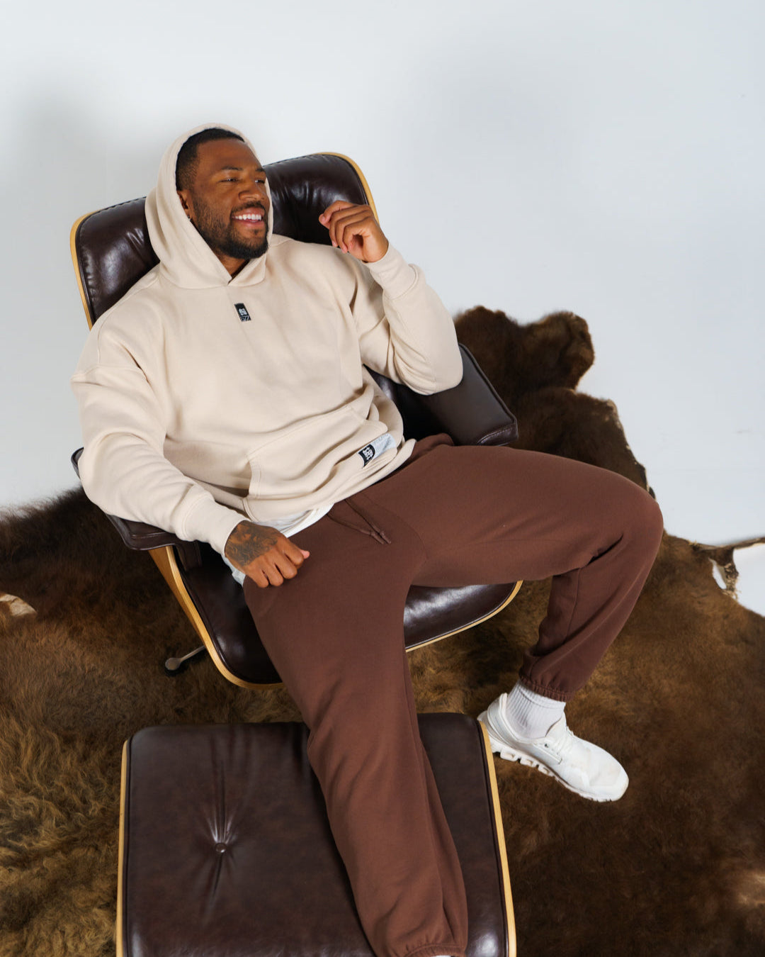 Man sitting on a massage chair with a neutral background