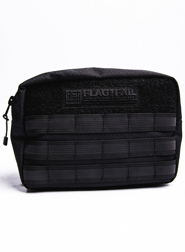 Photo of the front of the 6in Utility Pack. The Pouch has a zipper on the top with three rows of nylon loops. Features a Flag Nor Fail logo patch at the top of the Pouch.