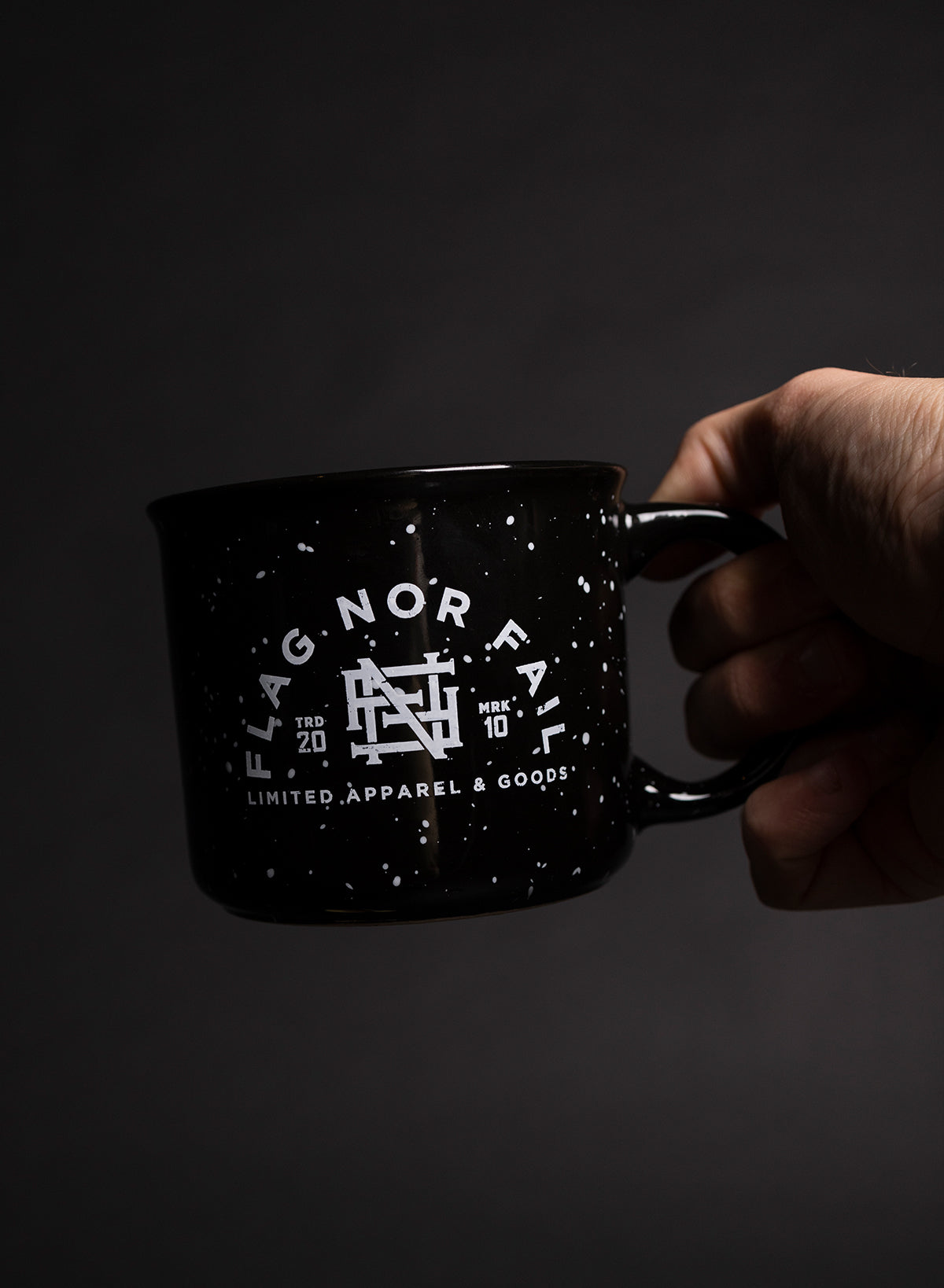 Ceramic mug. Black in color with white speckles. Featuring a white Flag nor Fail logo.